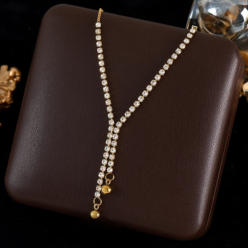 diamond necklace with gold accents on a brown surface