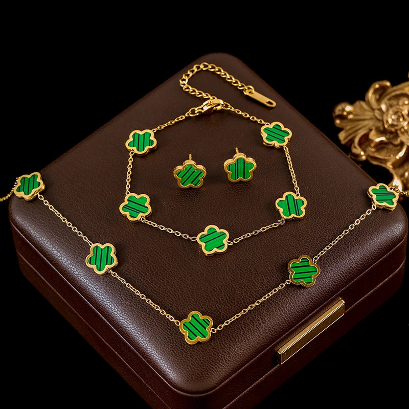 Jewelry set with green clover designs on a brown box