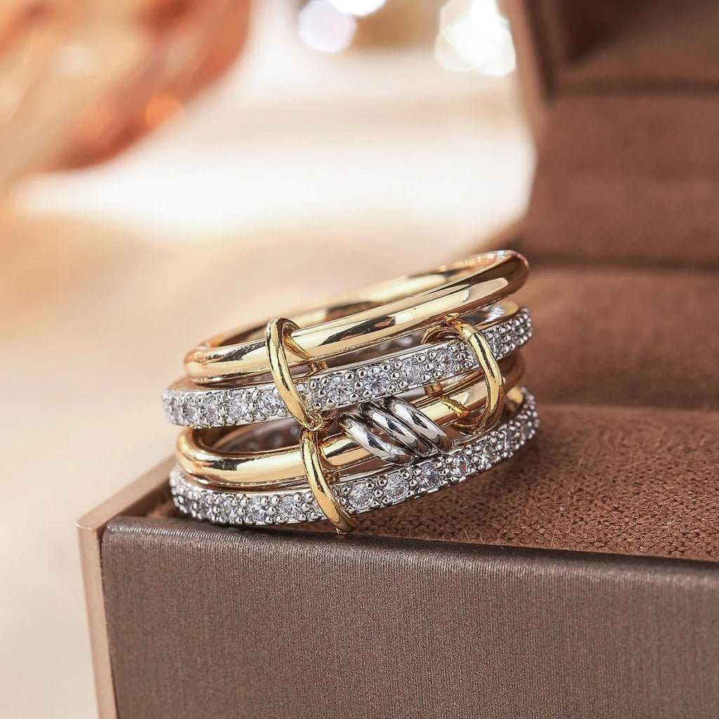 Stack of gold and silver rings on a brown box