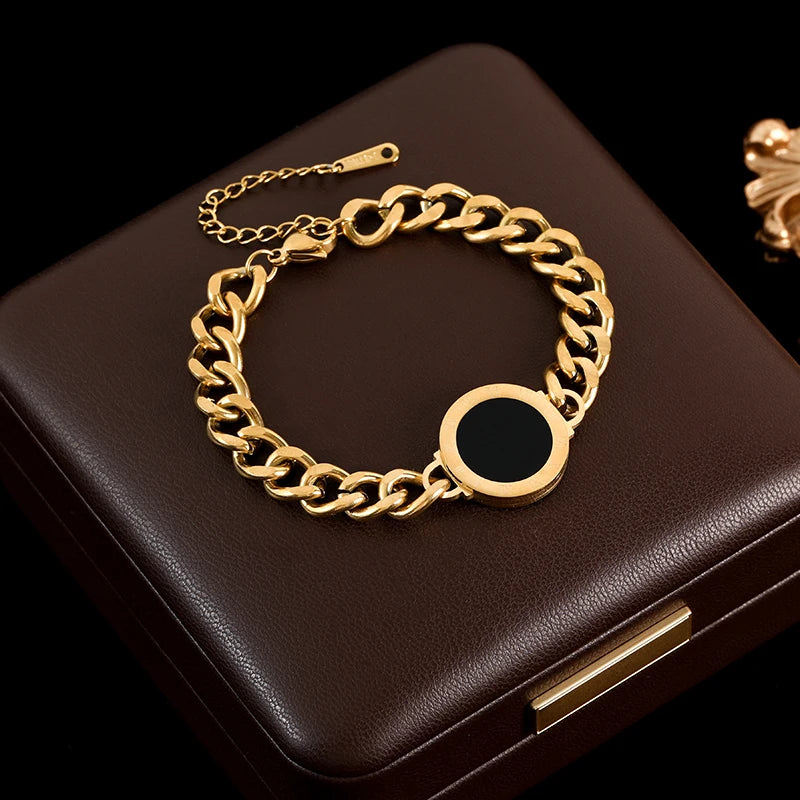 Gold chain bracelet on a dark brown box