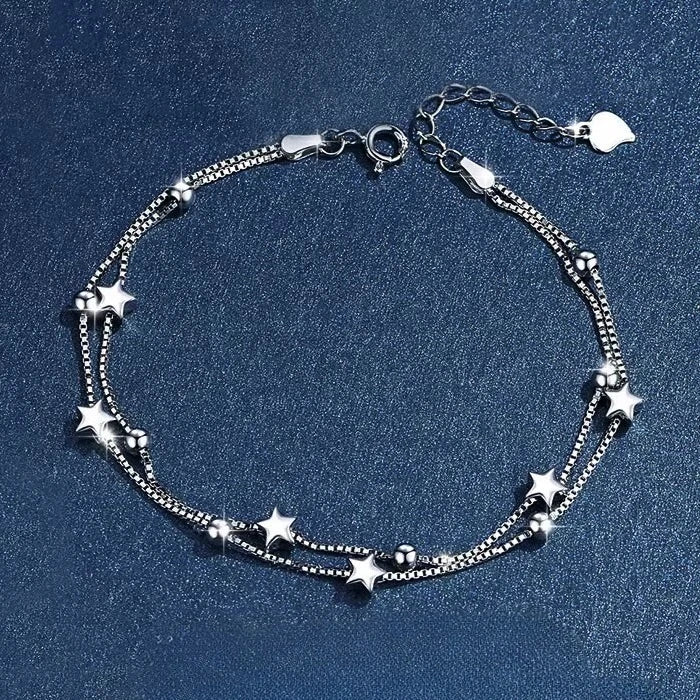Silver star bracelet on a blue background