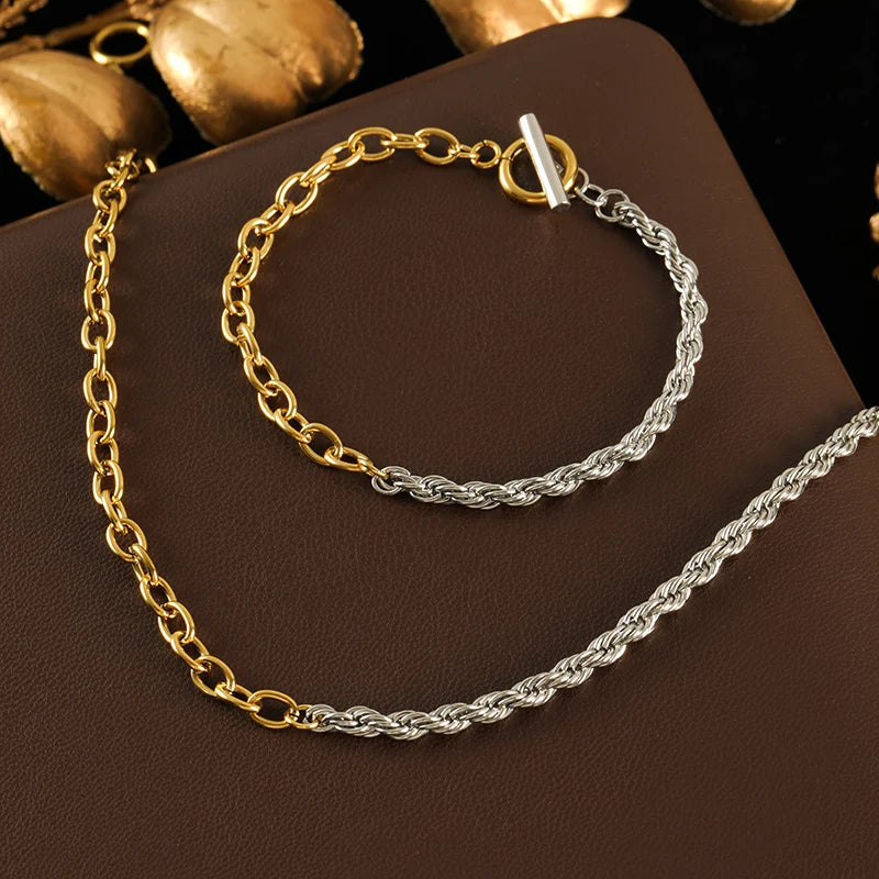 Gold and silver chain necklaces on a brown surface
