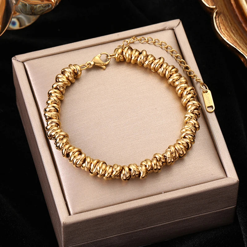 Gold bracelet on a jewelry box with a dark background